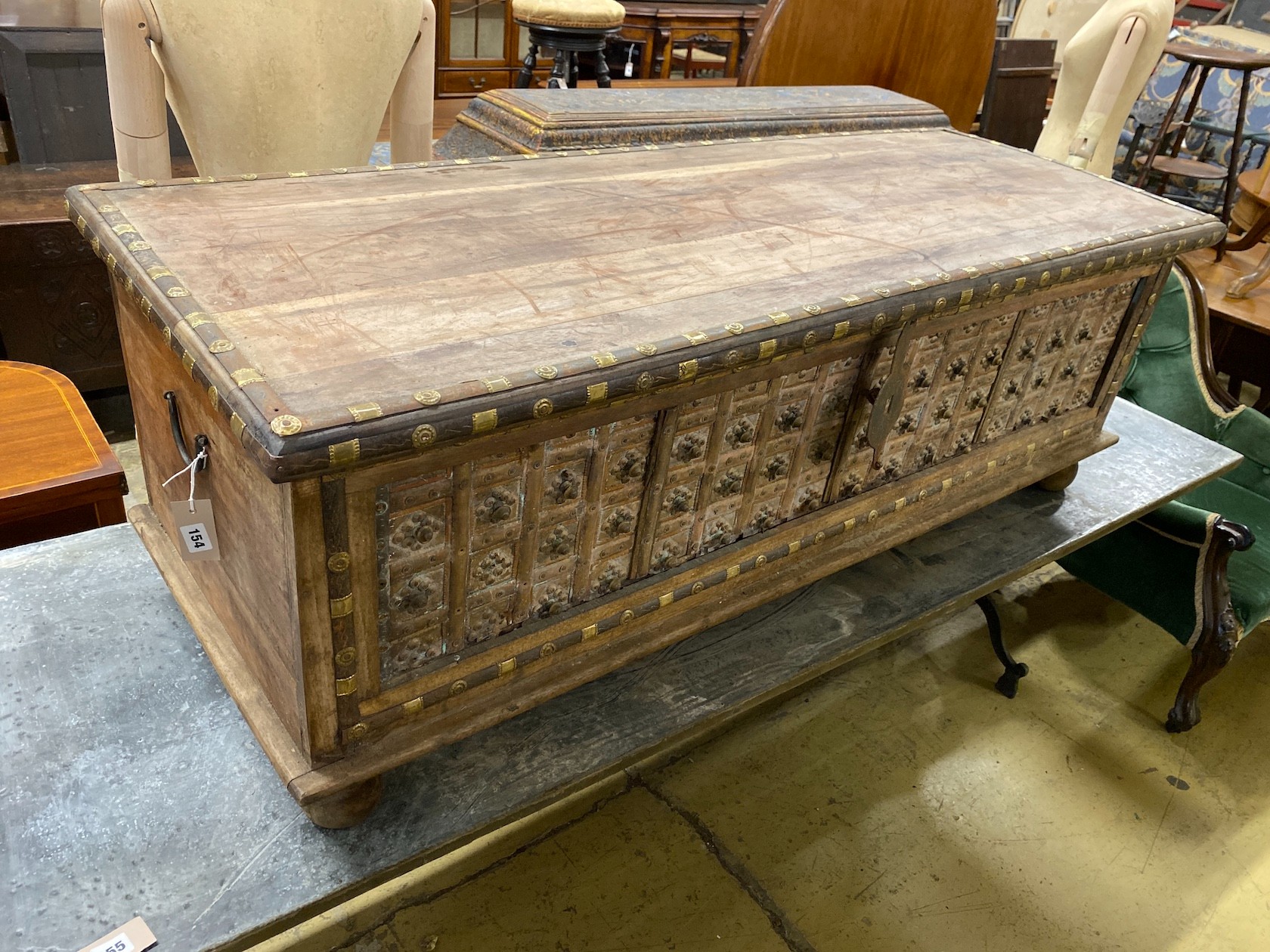 A South Asian brass mounted carved hardwood coffer, length 145cm, depth 55cm, height 50cm